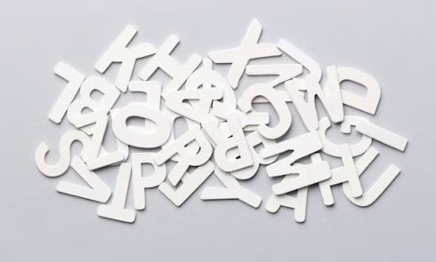Top view of pile of alphabet letters on white background